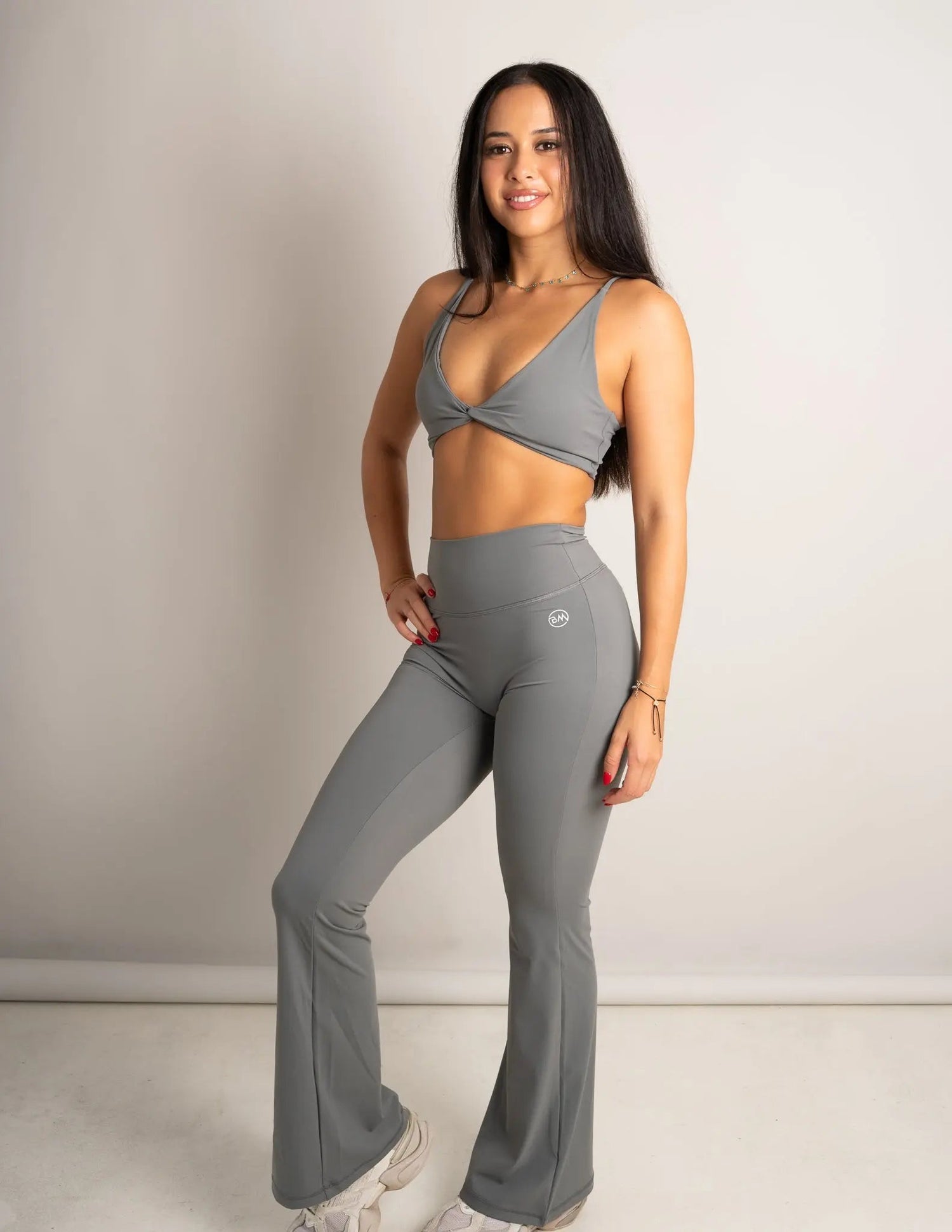 Model wearing Spark Twist Bra and Spark Leggings in Slate - Barmelle